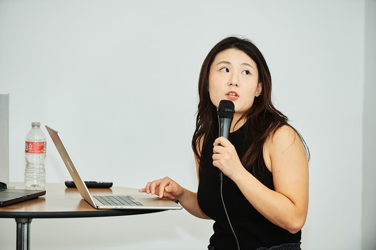 Speaker presenting with a laptop